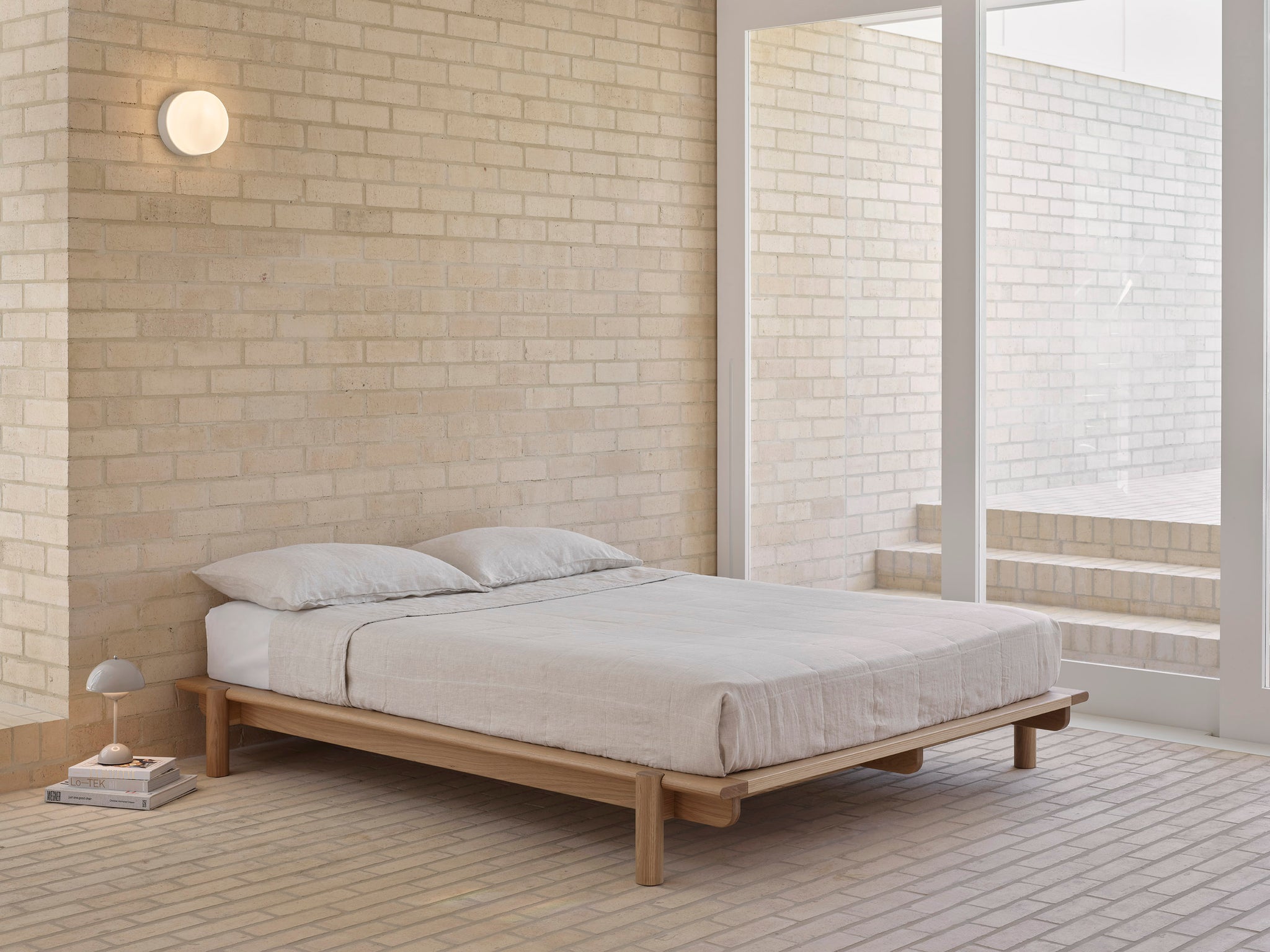 Title Bed 01 in white oak in a modern, brick home